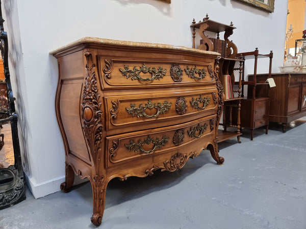 Impressive Louis XV style three drawer walnut commode. Ormolu handles and bevelled marble top complimenting detailed carving. In very good original detailed condition.