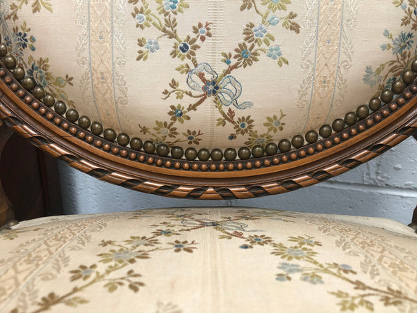 Pair of Antique French Louis XVI style carved Walnut fauteuils in restored condition. The Tapestry upholstery is in good condition some marks and wear but usable.