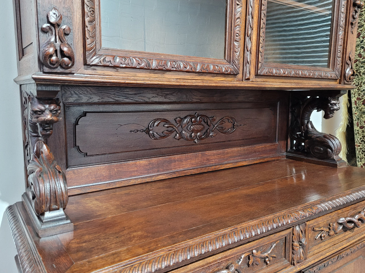 Grand French Oak Gothic style buffet with amazing detailed carvings. This stunning buffet has a display section at the top with two adjustable shelves, two drawers in the middle with elegantly carved handles and storage below with one fixed shelf. It is in good original detailed condition.