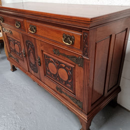 Beautiful decorative Art Nouveau sideboard with lovely handles and beautiful carved detailing. It is in good original detailed condition.