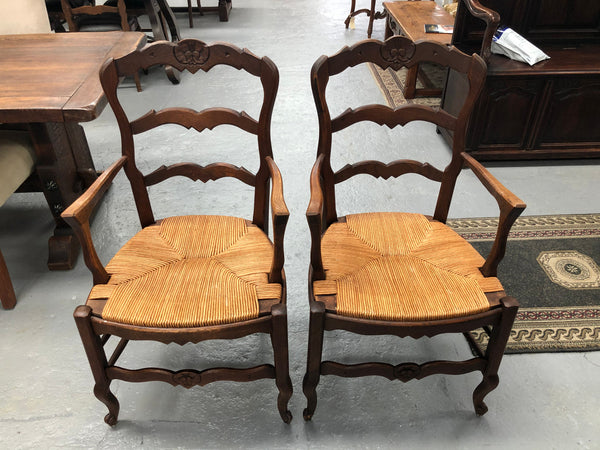 A hard to find French pair of rush seat carver chairs. They are in good original detailed condition.