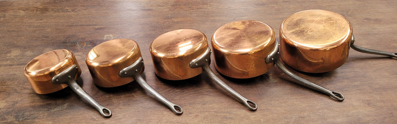 Set of five copper sauce pans with foundry stamp. They have been sourced from France and are in good original detailed condition.