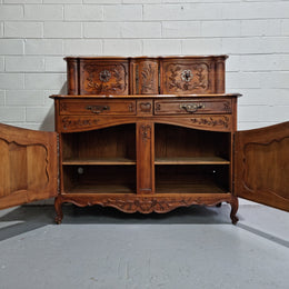 Stunning 19th Century French Walnut Buffet à Glissant from Provence, France. This is an exceptional charming piece and very functional with plenty of storage space, two large cupboards at the bottom, two drawers in the middle and two sliding doors either side at the top and finished off with a small central cupboard. In good original detailed condition.
