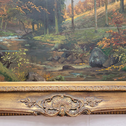 Large signed oil on canvas depicting a river stream in autumn framed in a stunning gilt frame. Sourced from France and is in good original detailed condition.