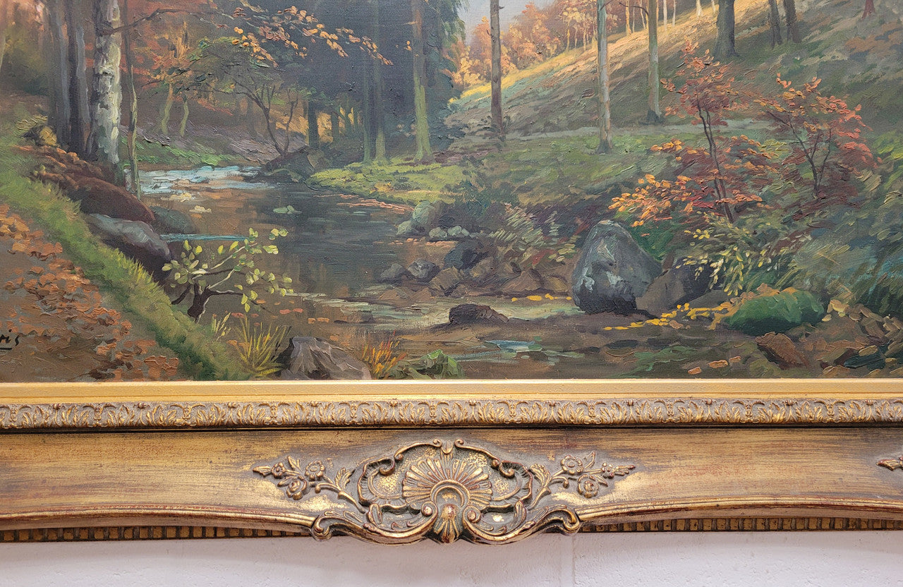 Large signed oil on canvas depicting a river stream in autumn framed in a stunning gilt frame. Sourced from France and is in good original detailed condition.