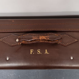 Impressive solid leather suitcase, moire fabric lined with leather straps to hold contents. Displays gold initials F.S.A near handle. With key. Please view photos as they help form part of the description.