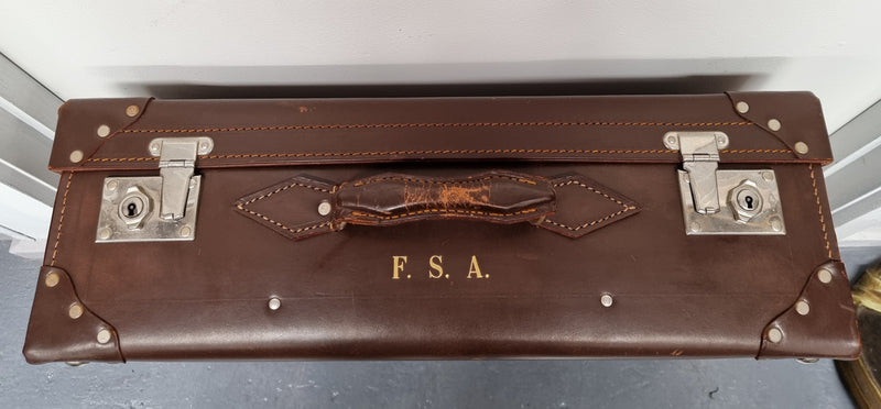 Impressive solid leather suitcase, moire fabric lined with leather straps to hold contents. Displays gold initials F.S.A near handle. With key. Please view photos as they help form part of the description.