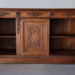 Stunning 19th Century French Oak Renaissance style sideboard base of hard to find dimensions. Amazing detailed carving with three cupboards and three drawers. It is in good original detailed condition.