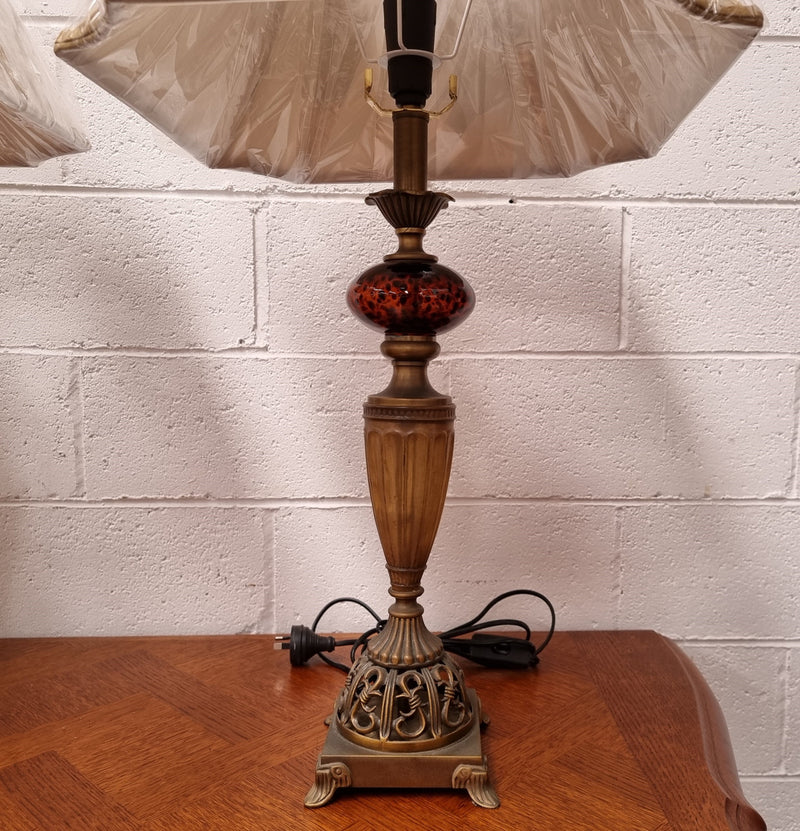 Beautiful pair of metal and glass lamp bases with new gold shades. They are in good original working condition and have been sourced locally.