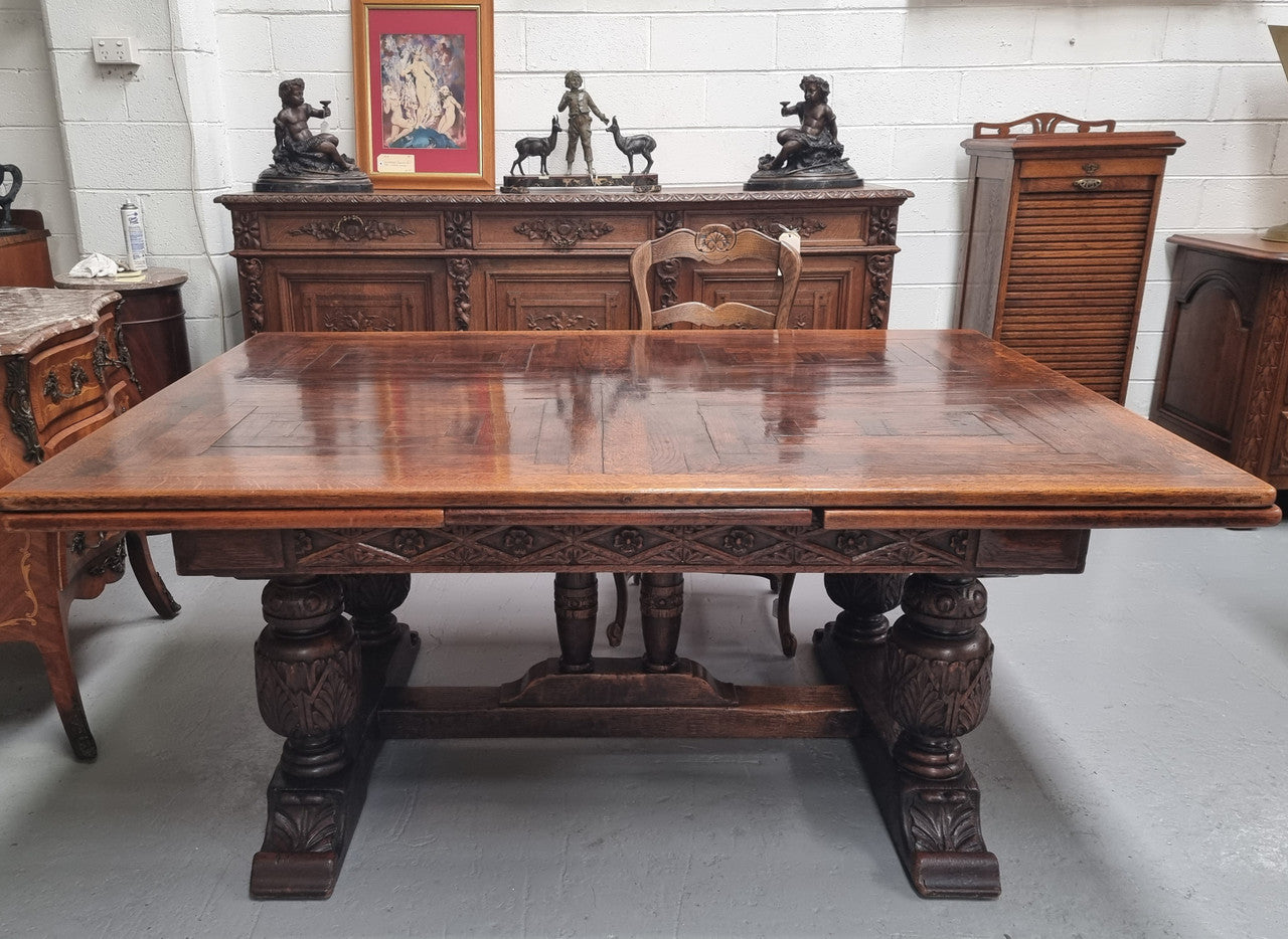 Renaissance style Oak extension table with parquetry top and twin pedestal base. The table extends by pulling out an extension leaf either side making it 287 cm long. Sourced from France and in good original detailed condition.