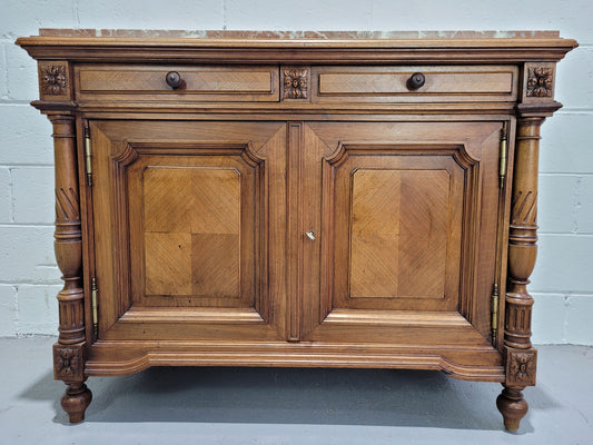 Stunning French walnut Henry II style marble top side cabinet with two drawers and two shelves inside. In good original detailed condition.
