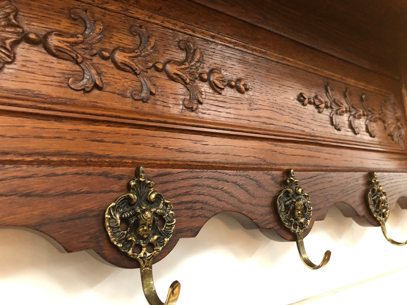 Beautiful French carved coat/hat rack with five decorative brass hooks and lovely detail in good condition.