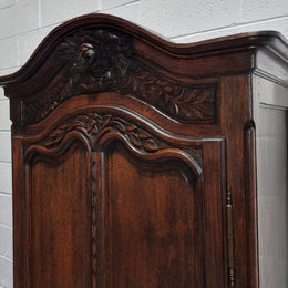 An Attractive French Louis XV style single-door ‘Marriage Armoire’. Beautifully arched crest with detailed carved flowers along with an arched single door which repeats the floral carvings. It is also has plenty of storage space with three adjustable shelves along with a drawer at the bottom. All in good original detailed condition.