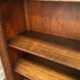Lovely Two door bookcase sourced from France with two adjustable shelves on each side and of narrow proportions. It also has lovely detail carving and  in good original detailed condition.