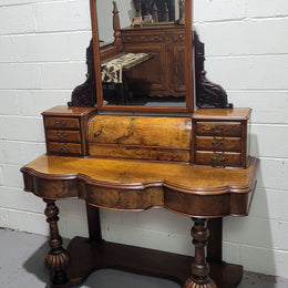 An elegant Victorian Figured Walnut dressing table with tilit mirror and a stunning fine Firgured Walnut serpentine shaped front. It has been sourced locally and is in good original detailed condition.