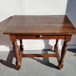Rustic French Oak side table or desk with single drawer and turned legs. In good original detailed condition.