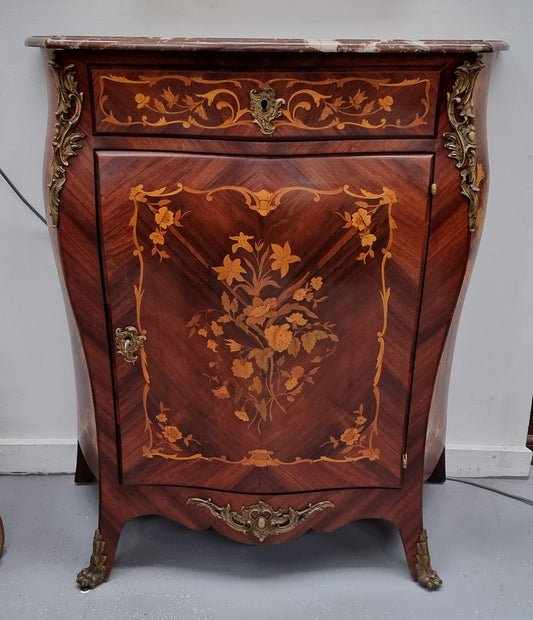 Stunning French Transitional style Mahogany marquetry inlay salon cabinet in the bombe shape. It has one draw, one shelf, marble top & ormolu decoration. Sourced from France and in good original detailed condition.