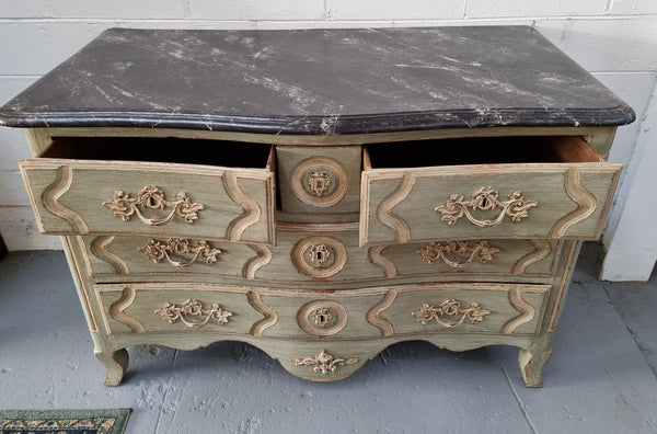 Early 19th Century Louis XIV style faux marble top and painted base commode. It is of large proportions and has four drawers. In good original detailed condition.