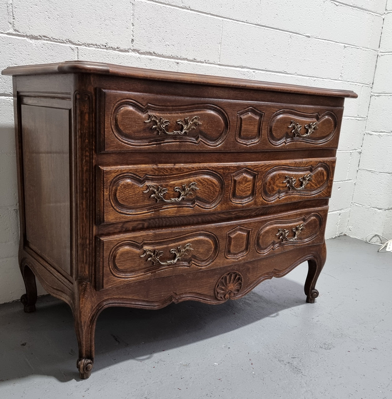 Lovely French nicely carved chest of 3 drawers with a parquetry top, with decorative handles and lovely carving. In good detailed condition.