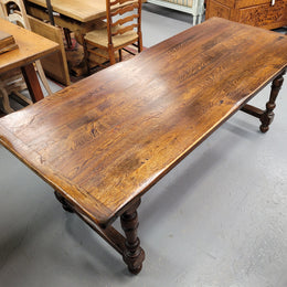 Rustic French Oak stretcher based farmhouse dining table that comfortably seats 6-8 people. It has been sourced from France and is in good original condition.