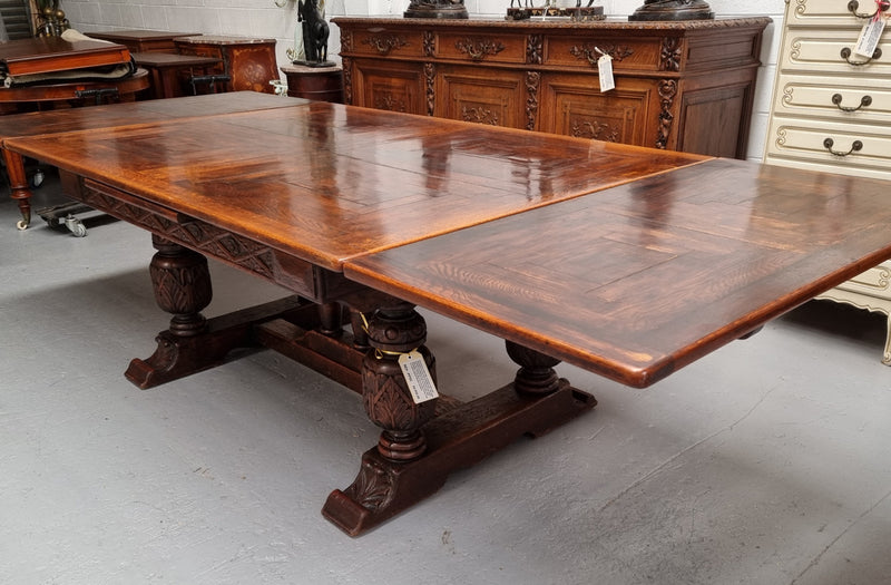 Renaissance style Oak extension table with parquetry top and twin pedestal base. The table extends by pulling out an extension leaf either side making it 287 cm long. Sourced from France and in good original detailed condition.