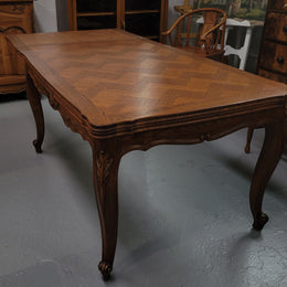 French Oak Louis XV style parquetry top extension table. It can sit six people when not extended and eight when fully extended. It has been sourced from France and is in original detailed condition.
