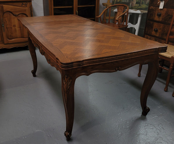 French Oak Louis XV style parquetry top extension table. It can sit six people when not extended and eight when fully extended. It has been sourced from France and is in original detailed condition.