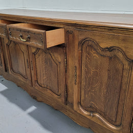 Late 19th Century French carved Oak Louis XV style four drawer sideboard. Plenty of storage space with four cupboards and two drawers. It is in good original detailed condition with all locks functioning with keys.
