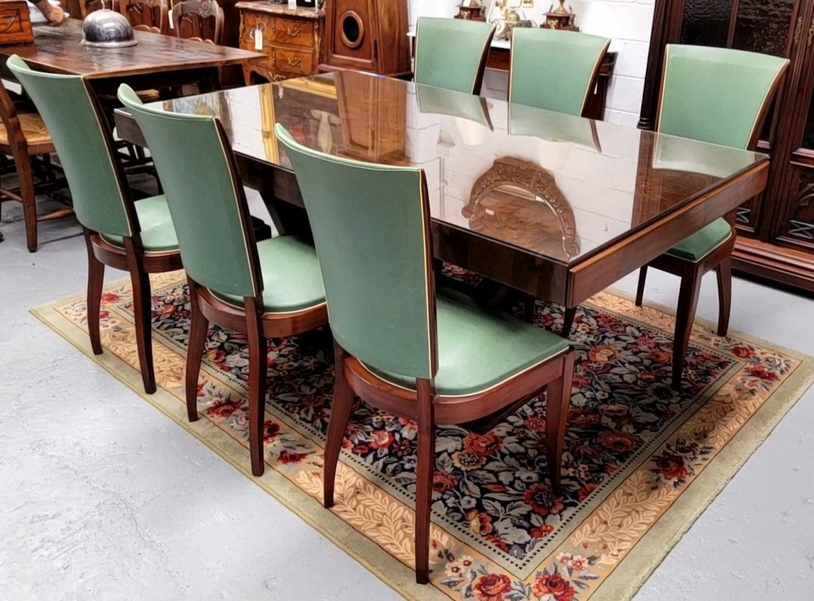 French Art Deco Figured Walnut dining table and six chairs. This stylish table also comes with a glass top and can be used with or without it. The chairs are very comfortable and the table can also fit another two chairs at either end making it a 6-8 seater. The table is in good original detailed condition with character marks to the top of table as shown in the pictures. This table and six chairs have been sourced locally.