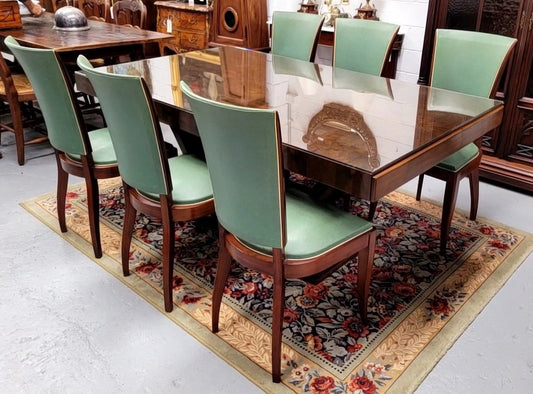 French Art Deco Figured Walnut dining table and six chairs. This stylish table also comes with a glass top and can be used with or without it. The chairs are very comfortable and the table can also fit another two chairs at either end making it a 6-8 seater. The table is in good original detailed condition with character marks to the top of table as shown in the pictures. This table and six chairs have been sourced locally.