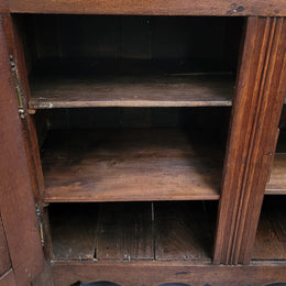 A charming French Oak early 18th Century two door sideboard. Plenty of storage space with two fixed shelves either side. It is in good original detailed condition for its age and comes with  a working key and working locks.