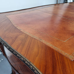 An impressive French kingwood and ormolu mounted bureau plat. It has a brown tooled leather writing surface, three decorated frieze drawers to the shaped apron with foliate swing handles and well cast figural mounts. Beautiful cabriole legs with decorative ormolu mounts and trims throughout. In good original detailed condition.