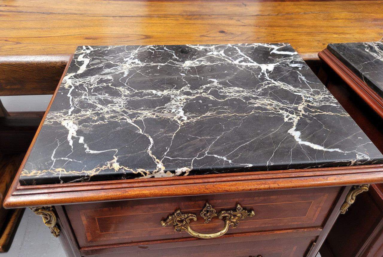 Appealing Louis XV style high quality bedside cabinets with black Portoro marble top and bronze mounts. They have been sourced from France and are in good original condition.