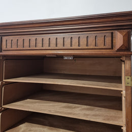 French Henry II style Walnut linen storage cupboard with nine pull out shelves. This piece could be very functional for a range of different purposes including shoe storage. It is in good original detailed condition, please note the door lock no longer functions and opens by pulling the door.