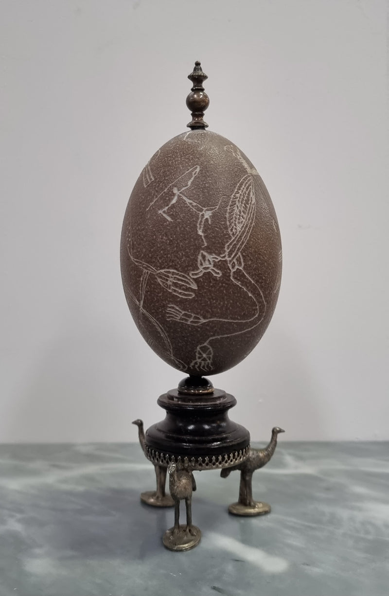Superbly carved Emu egg on a emu metal and ebony base. It depicts an Aboriginal hunting scene and dreaming's. It is in good original condition, please view photos as they help form part of the description.