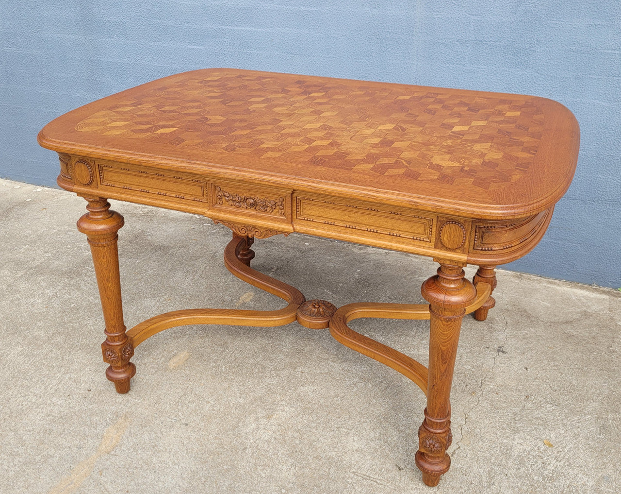 Beautiful carved French Oak dining table with a parquetry top and six matching upholstered chairs. All in good original detailed condition.