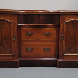 An English Victorian Mahogany sideboard with nine drawers. This amazing piece has loads of storage with three central drawers in the middle and a further six drawers. It has three each side located behind two doors. It has been sourced from locally and in original detailed condition.
