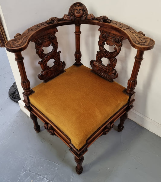 Beautifully carved French Walnut corner chair with upholstered seat. In good original detailed condition.