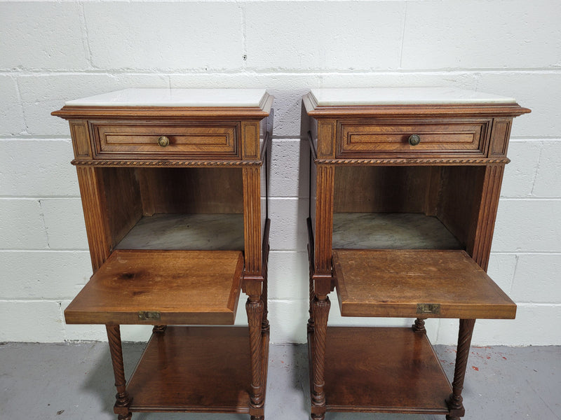 Pair parquetry Walnut bedside cabinets with white inset marble tops. In good original detailed condition.