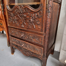 Petite oak armoire display cabinet with a glass door, two drawers at the bottom and three shelves inside. Late 18th Century and amazing detailed decorative carvings. Sourced from France and in good original condition.
