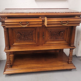 Stunning Henry II style French Walnut marble top buffet. It has a beautiful marble top and plenty of storage with two drawers, two doors with beautiful decorative carvings and an open shelf. It has been sourced from France and is in good original condition and has been detailed to a high standard.