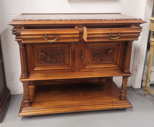 Stunning Henry II style French Walnut marble top buffet. It has a beautiful marble top and plenty of storage with two drawers, two doors with beautiful decorative carvings and an open shelf. It has been sourced from France and is in good original condition and has been detailed to a high standard.