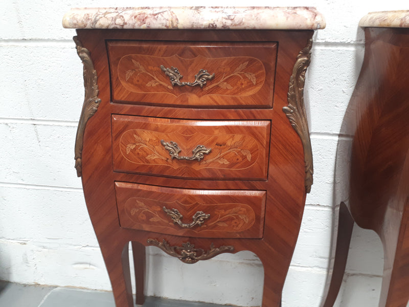 Pair of French Louis XV style miniature commode bedsides. Beautiful marquetry inlay and marble tops. In very good original condition.