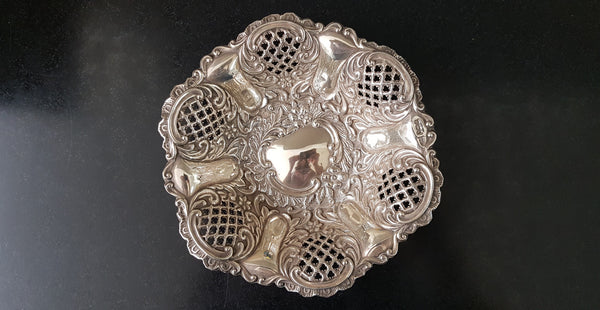 A Sheffield sterling silver bowl with repousse pattern, hallmarked WALKER & HALL and in good original condition.