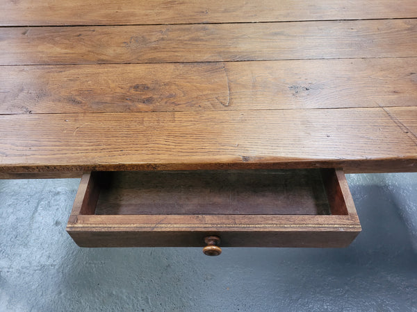 Provincial 19th Century French Oak rustic farmhouse table with tapered leg and single drawer. It has been sourced from France and is in good original detailed condition. 