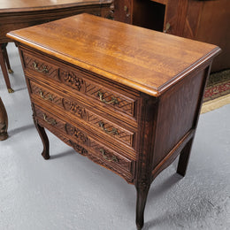 Rustic Louis XV style Oak petite three drawer chest featuring attractive carvings. It has been sourced locally and it is in good original detailed condition.