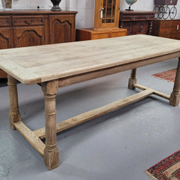 Beautilful raw solid oak French pedestal extension table. It has been sourced from France and is in good original detailed condition. When the table is fully extended it is 339 cm long and can comfortable seat 10-12 people. Features raw wood that could be used as is for a distressed look, or finished and waxed for a more refined look.