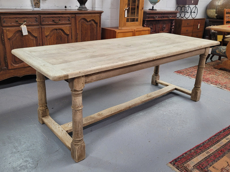 Beautilful raw solid oak French pedestal extension table. It has been sourced from France and is in good original detailed condition. When the table is fully extended it is 339 cm long and can comfortable seat 10-12 people. Features raw wood that could be used as is for a distressed look, or finished and waxed for a more refined look.