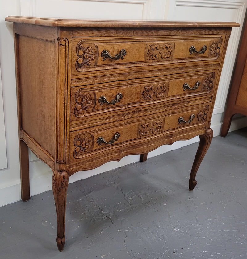 French Oak Louis 15th style nicely carved three drawer wooden top commode. It has been sourced from France and is in good original detailed condition.