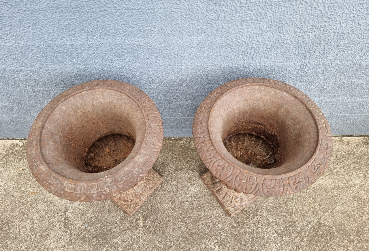 Beautiful pair of French rustic cast iron urns with handles. They would look fabulous in the garden or inside. They are very heavy an in good original condition.